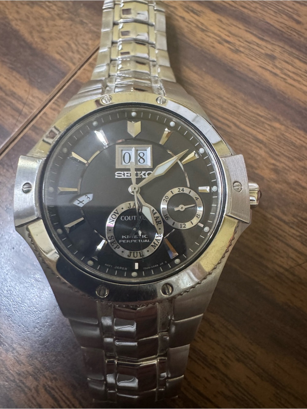 Seiko Silver-Stainless Steel Watch with Black Dial and Gold Accents